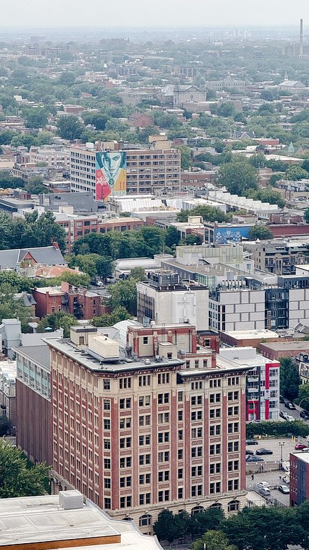 My office building offers a view of the Quartier des Spectacles, a vibrant area filled with festivals year-round. Notice the building with the painted woman's face, looking at me. Mesmerizing.