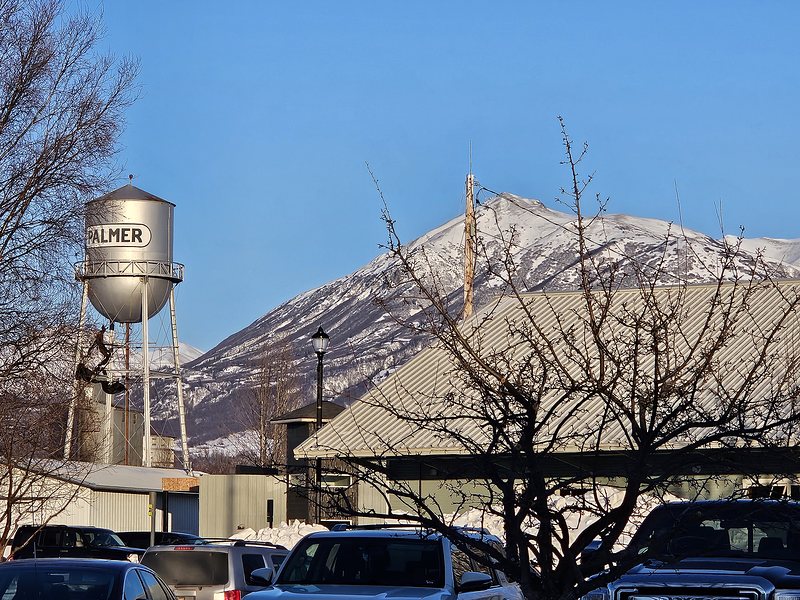 Mountains in the background with a water tower that says "Palmer".