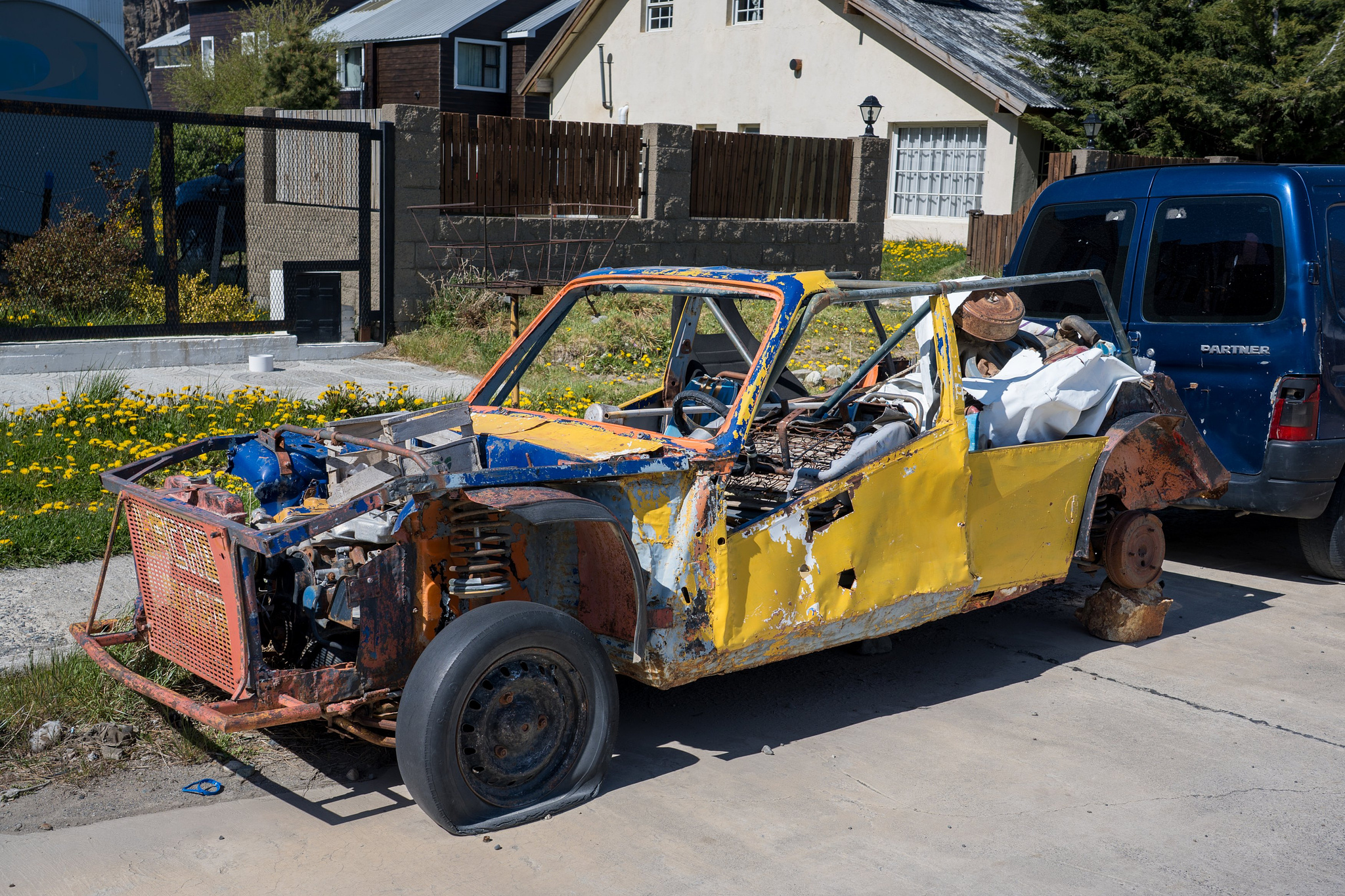 A really old ruined car painted yellow