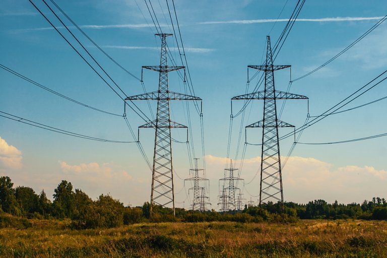 Photo of large energy pylons running through a field